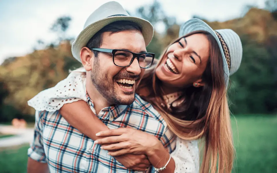 happy man and woman wearing hats